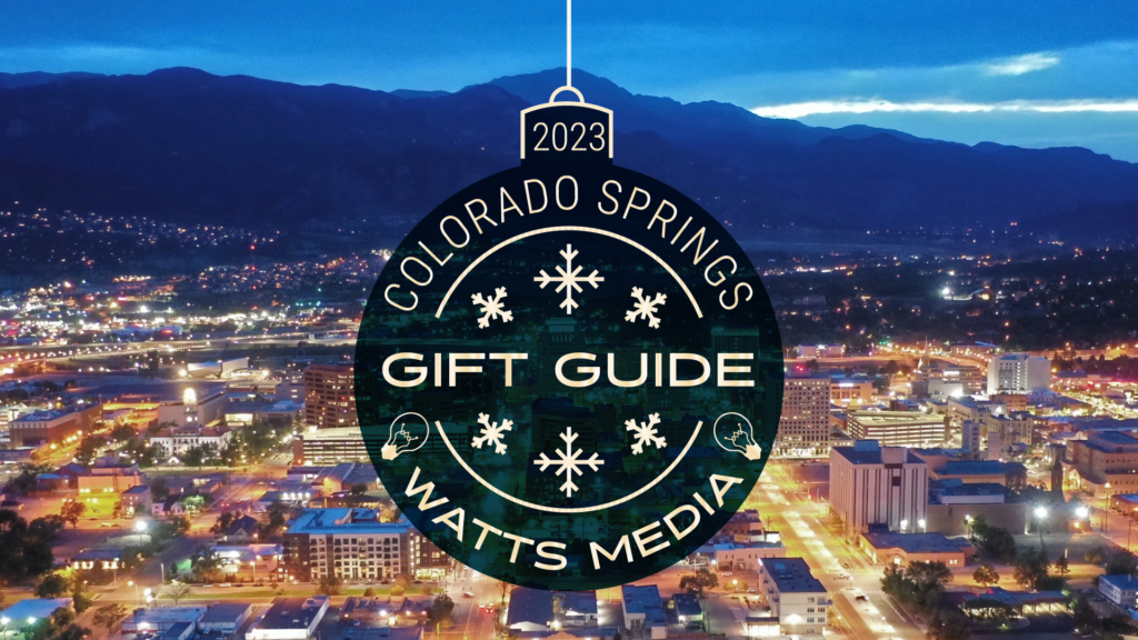 Colorado Springs looking west over a night sky with a holiday "gift guide" graphic overlaid on top.
